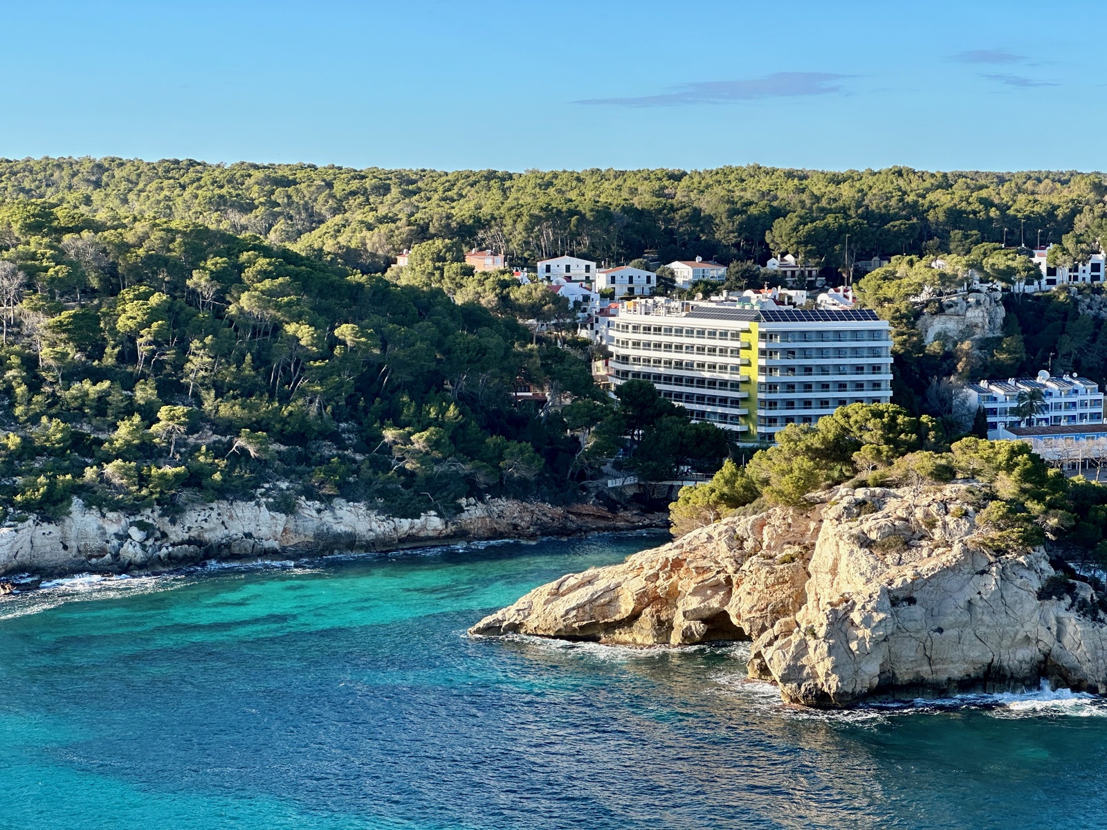 Hotel and villas perched on limestone cliffs above the turquoise waters of Cala Galdana
