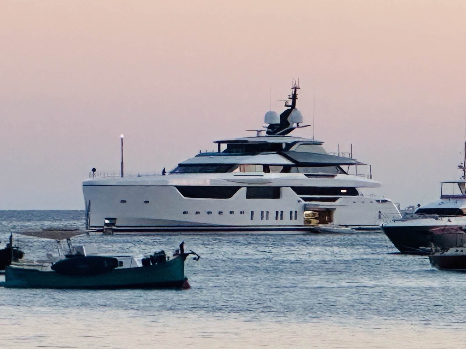 Luxury superyacht anchored in the bay at dusk with pastel sky